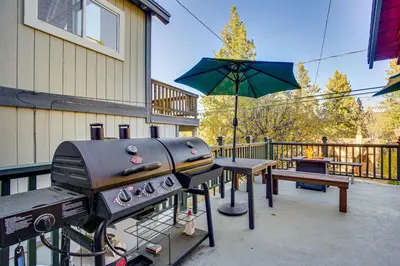 a grill and a picnic table with an umbrella at Hot Tub, Grill and Fire Pit Cabin in Big Bear Lake in Big Bear Lake