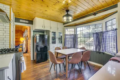 a kitchen and dining room with a table and chairs at Hot Tub, Grill and Fire Pit Cabin in Big Bear Lake in Big Bear Lake