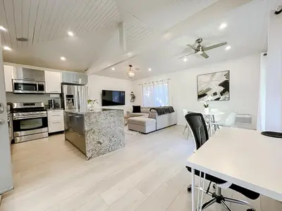 a large kitchen and living room with a table at Pristine 1BD 1BA Bungalow With Hot Tub in Los Angeles