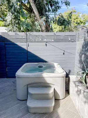 a toilet sitting on a patio next to a fence at Pristine 1BD 1BA Bungalow With Hot Tub in Los Angeles