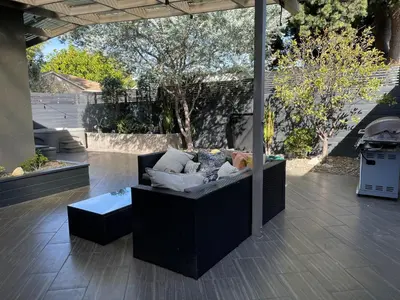 a black couch sitting on a patio at Pristine 1BD 1BA Bungalow With Hot Tub in Los Angeles
