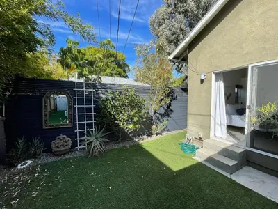 a small backyard with a yard with green grass at Pristine 1BD 1BA Bungalow With Hot Tub in Los Angeles