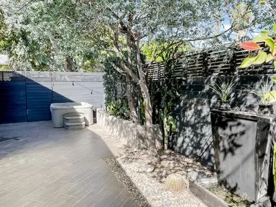 a toilet sitting on a patio next to a fence at Pristine 1BD 1BA Bungalow With Hot Tub in Los Angeles