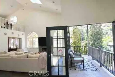 a living room with a couch and a balcony at Stunning Mediterranean Mansion in Laurel Canyon in Los Angeles