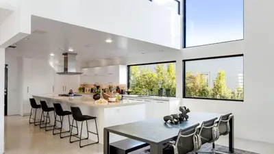 a kitchen with a table and chairs and a large window at Kings Road West Hollywood Luxury Pool Views Firepit Modern Design in Los Angeles