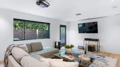 a living room with a couch and a table at Kings Road West Hollywood Luxury Pool Views Firepit Modern Design in Los Angeles