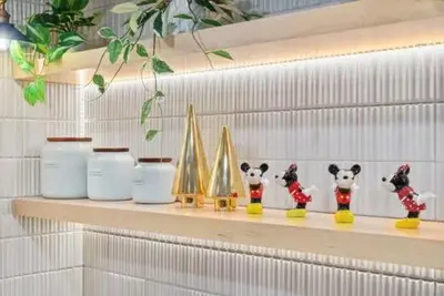 a shelf with figurines of pandas and sailboats on it at Modern Anaheim Stay- Minutes to Disney& Family Fun in Anaheim