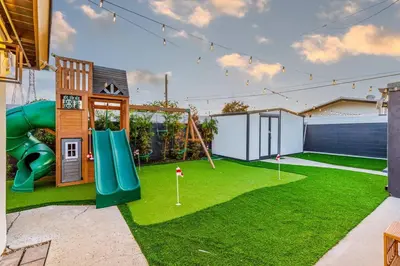 a backyard with a playground with a slide at Modern Anaheim Stay- Minutes to Disney& Family Fun in Anaheim