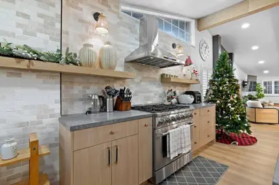 a kitchen with a christmas tree in the background at Modern Anaheim Stay- Minutes to Disney& Family Fun in Anaheim