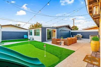 a house with a yard with a miniature golf course at Modern Anaheim Stay- Minutes to Disney& Family Fun in Anaheim