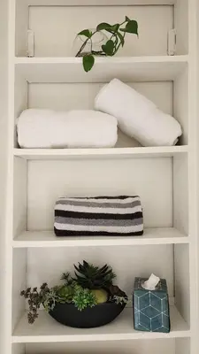 two white shelves with towels and plants on them at LAX House Near SoFi Stadium, Intuit Dome, YouTube Theater, The Kia Forum, Beaches in Inglewood
