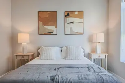 a bedroom with a large bed with two lamps at Hollywood Escape! Elegant 2BR 2BA Rental in Los Angeles