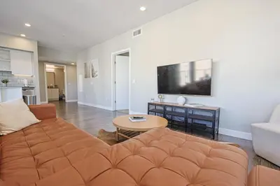 a living room with a couch and a tv at Hollywood Escape! Elegant 2BR 2BA Rental in Los Angeles