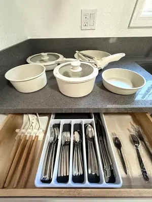 a kitchen counter with utensils in a sink at Sofi LAX Clippers Stay in Inglewood