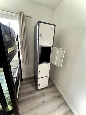 a room with a refrigerator and a bunk bed at Sofi LAX Clippers Stay in Inglewood
