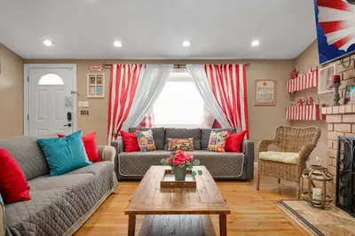 a living room with a couch and a table at Carnival Dream by OC Adventure Homes in Orange