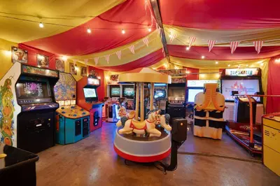 a room with arcade games and a video game at Carnival Dream by OC Adventure Homes in Orange