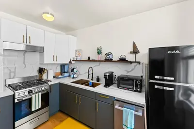 a kitchen with a black refrigerator and a sink at Ocean View Studio Near Convention Center and Beach in Long Beach