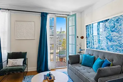 a living room with a couch and a large window at Ocean View Studio Near Convention Center and Beach in Long Beach