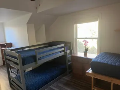 a bedroom with two bunk beds and a window at Enjoy Privacy - Pine Mountain - Spacious Home in Pine Mountain Club