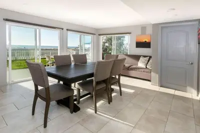 a dining room with a table and chairs and a couch at 90210 Beach House Lower Unit in Hermosa Beach