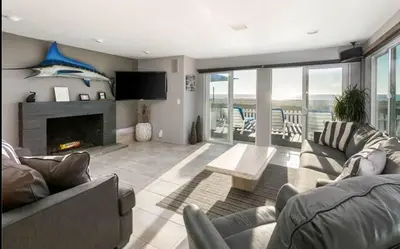 a living room with a couch and a fireplace at 90210 Beach House Lower Unit in Hermosa Beach