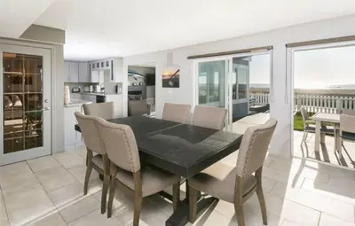 a dining room with a black table and chairs at 90210 Beach House Lower Unit in Hermosa Beach
