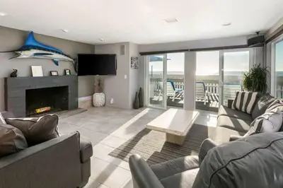a living room with a couch and a fireplace at 90210 Beach House Lower Unit in Hermosa Beach