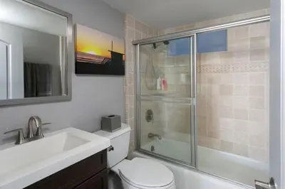 a bathroom with a shower and a toilet and a sink at 90210 Beach House Lower Unit in Hermosa Beach