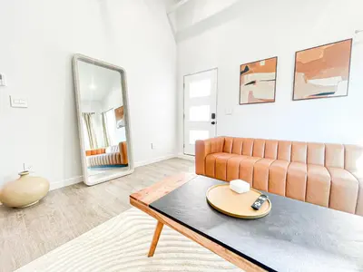 a living room with a couch and a table at Sunny 1BR with Large Outdoor Lounge Space - SH4LAD in Los Angeles