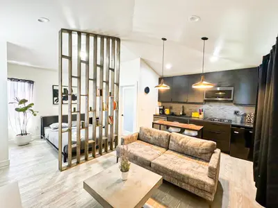 a living room with a couch and a kitchen at Charming Poolside ADU Near SoFi Stadium - MK3LAD in Los Angeles