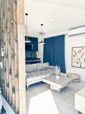 a living room with a couch and a table at Charming Poolside ADU Near SoFi Stadium - MK3LAD in Los Angeles