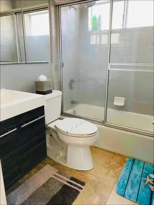a bathroom with a toilet and a shower and a sink at 90210 Beach House Top Unit in Hermosa Beach