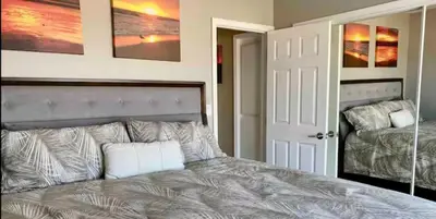 a bedroom with a bed with a white pillow on it at 90210 Beach House Top Unit in Hermosa Beach