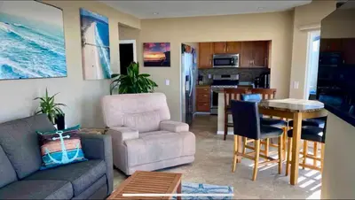 a living room with a couch and a table at 90210 Beach House Top Unit in Hermosa Beach
