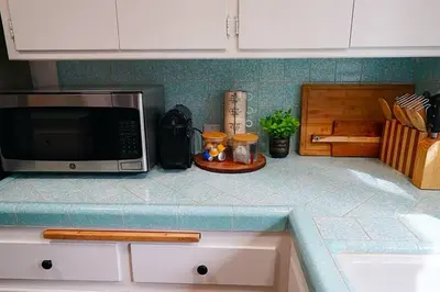 a kitchen counter with a microwave on top of it at Beautiful Renovated Cozy Forest Home with Hot Tub in Crestline in Crestline