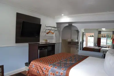 a bedroom with a bed and a flat screen tv at Galaxy Inn in Los Angeles