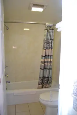 a bathroom with a bath tub and a toilet at Galaxy Inn in Los Angeles