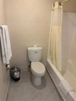 a bathroom with a toilet and a shower and a tub at Best Star Inn - Montebello, Los Angeles in Montebello