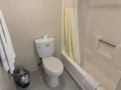 a bathroom with a toilet and a bath tub at Best Star Inn - Montebello, Los Angeles in Montebello