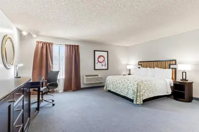 a hotel room with a bed and a desk at HomeTowne Studios by Red Roof Ridgecrest in Ridgecrest