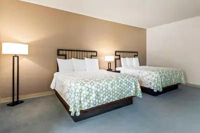 a hotel room with two beds and two lamps at HomeTowne Studios by Red Roof Ridgecrest in Ridgecrest