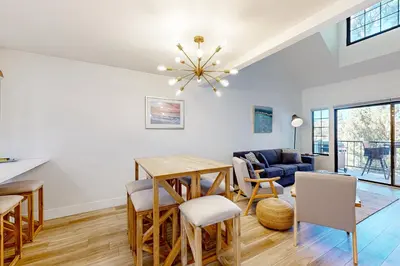 a dining room and living room with a table and chairs at Lake Arrowhead Views! Condo with Shared Pool and Spa in Lake Arrowhead