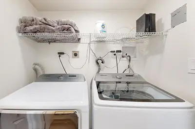 a laundry room with a washing machine and a drying rack at Lake Arrowhead Views! Condo with Shared Pool and Spa in Lake Arrowhead