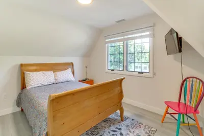 a bedroom with a bed and a window and a chair at 1 Mi to Dtwn Pasadena! Newly Built Home in Pasadena