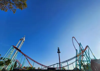 a roller coaster in a park with a blue sky at Charming Bedroom Near Disney Land, Orange County in La Palma
