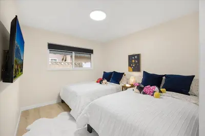 a bedroom with two beds with stuffed animals on them at Luxurious Newly Remodeled 4 Bedroom Home with Large Backyard near Disneyland in Anaheim