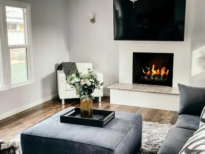 a living room with a couch and a fireplace at Lovely home close by SOFI Stadium in Inglewood