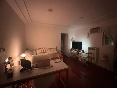 a bedroom with a bed and a table with a laptop at Cozy Studio In West Hollywood in Los Angeles
