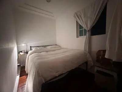 a bedroom with a white bed and a window at Cozy Studio In West Hollywood in Los Angeles